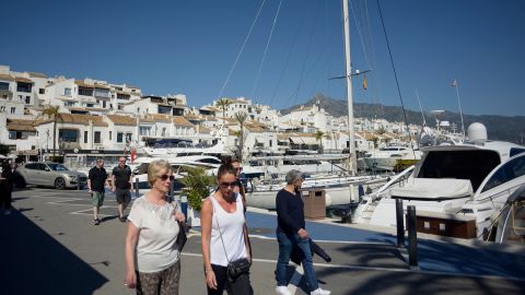 People stroll in Puerto Banus luxury marina and shopping complex in Marbella on March 2, 2022. - Marbella is one of the favorite destinations for Russian tourists and residents in Spain. (Photo by JORGE GUERRERO / AFP) (Photo by JORGE GUERRERO/AFP via Getty Images)