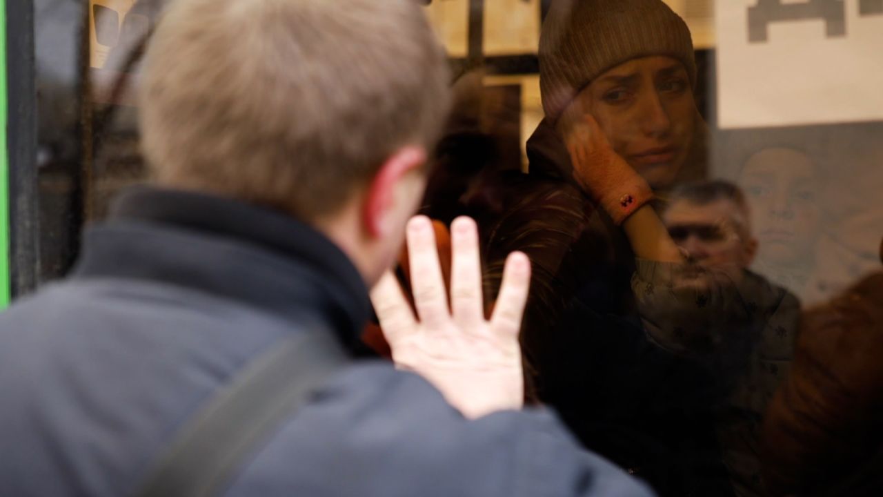 Oeksandr waves goodbye to his son through the bus window in Mykolaiv.