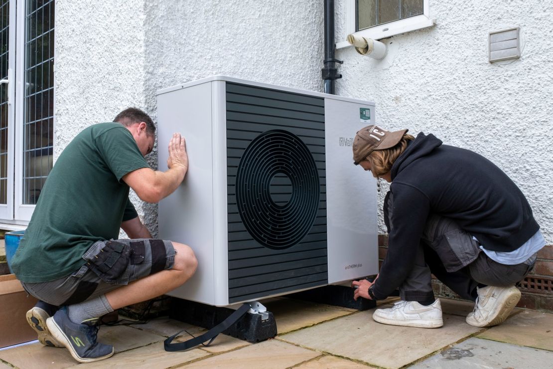 Workers install a heat pump in Folkestone, England. 