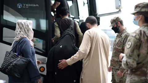Refugees board a bus at Dulles International Airport that will take them to a refugee processing center after being evacuated from Kabul following the Taliban takeover of Afghanistan on August 31, 2021 in Dulles, Virginia.
