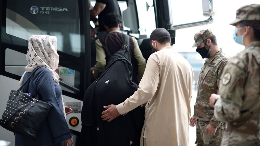 DULLES, VIRGINIA - AUGUST 31: Refugees board a bus at Dulles International Airport that will take them to a refugee processing center after being evacuated from Kabul following the Taliban takeover of Afghanistan on August 31, 2021 in Dulles, Virginia. The Department of Defense announced yesterday that the U.S. military had completed its withdrawal from Afghanistan, ending 20 years of war. (Photo by Anna Moneymaker/Getty Images)