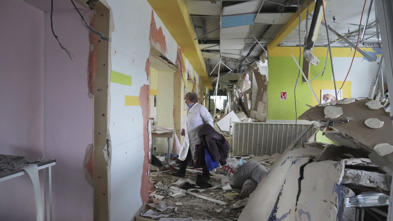 A medical worker walks through the hall of a maternity hospital damaged in a shelling attack on March 9 in Mariupol, Ukraine.