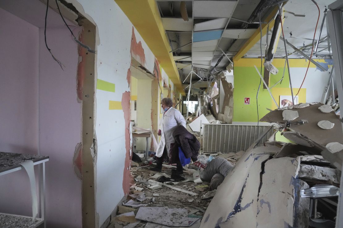 A medical worker walks through the hall of a maternity hospital damaged in a shelling attack on March 9 in Mariupol, Ukraine.
