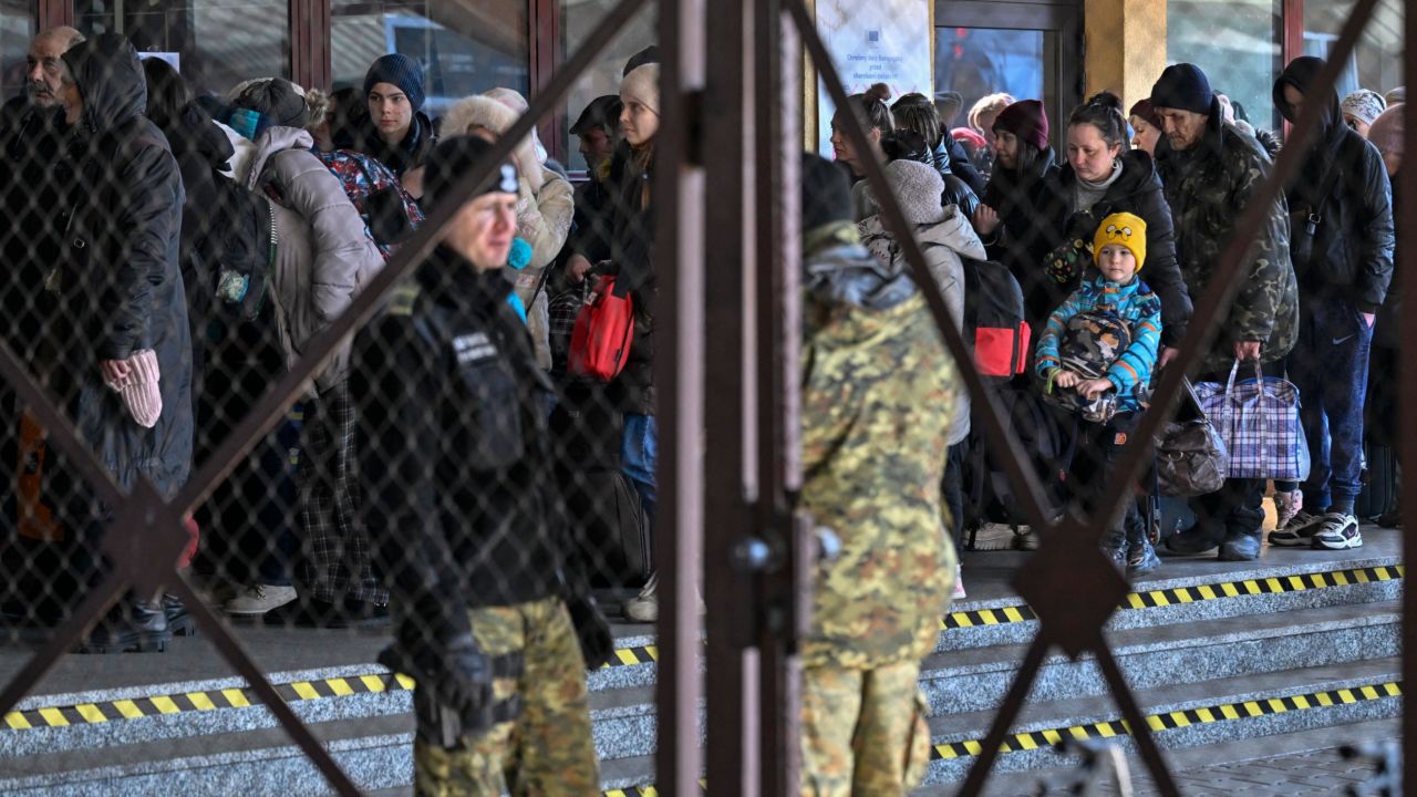 People line up Monday after arriving from Ukraine at the train station in Przemysl, near the Ukrainian-Polish border.