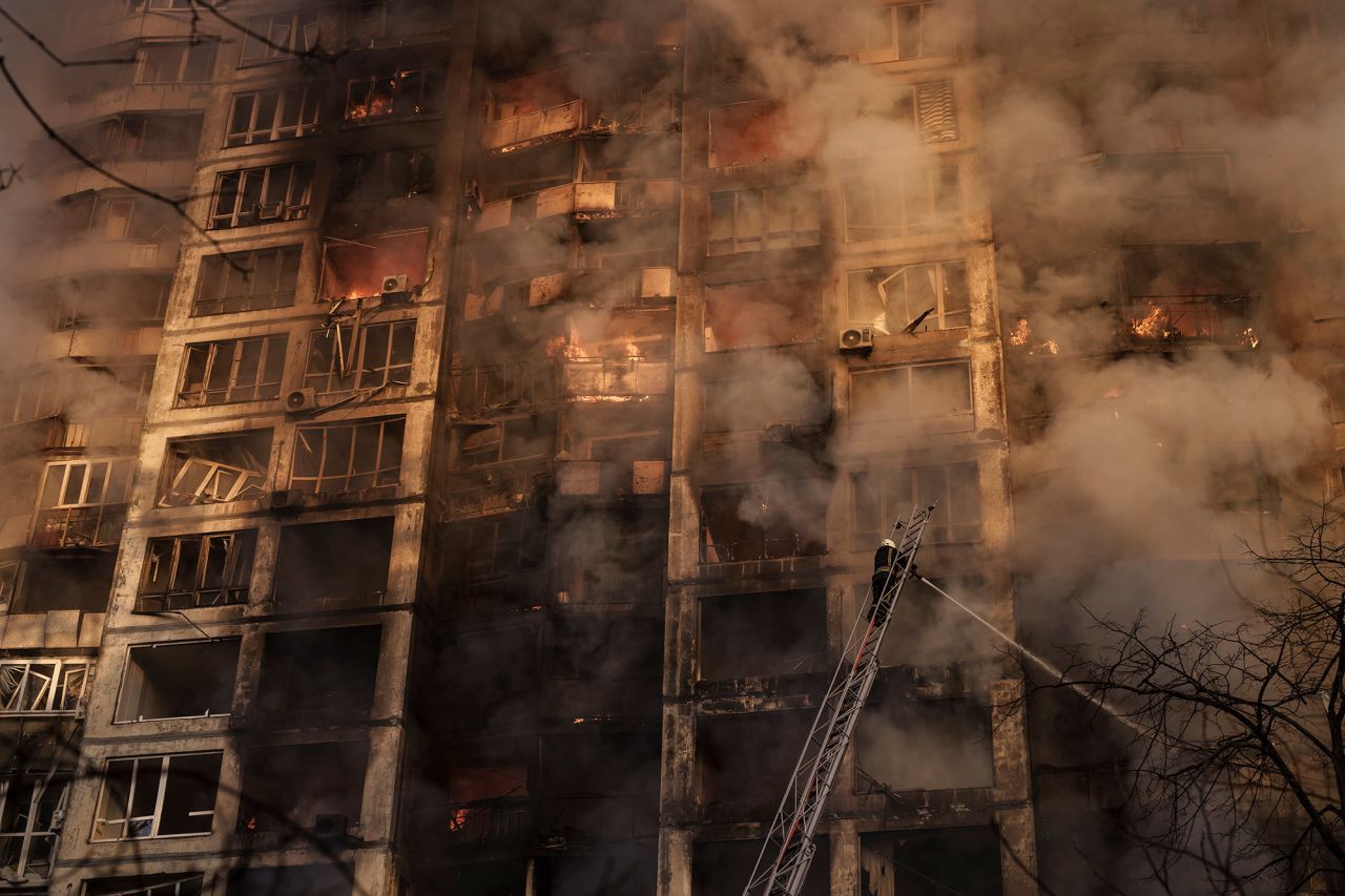 Firefighters work to extinguish flames at an apartment building in Kyiv on March 15.