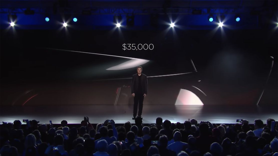 Elon Musk announcing the price of Tesla's Model 3 electric car during an unveiling event in 2016.