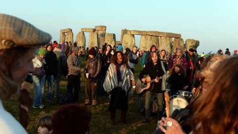 Oh, the pre-pandemic times! Revelers dance and play music during celebrations marking the spring equinox at Stonehenge in 2015. 
