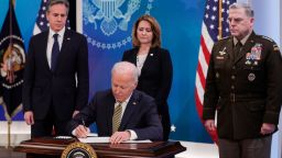 WASHINGTON, DC - MARCH 16: U.S. President Joe Biden signs legislative action to provide security aid and support to Ukraine as Secretary of State Antony Blinken (L), Deputy Secretary of Defense Kathleen Hicks and Chairman of the Joint Chiefs of Staff General Mark Milley look on, during an event in the South Court Auditorium at the Eisenhower Executive Office Building near the White House on March 16, 2022 in Washington, DC. President Biden delivered remarks on U.S. assistance to Ukraine as Russia's invasion of Ukraine enters its third week. 