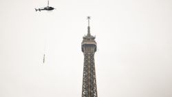 This photograph taken in Paris on March 15, 2022 shows a new antenna installed by a Eurocopter AS355N Ecureuil 2 at the top of the Eiffel Tower. (Photo by Christophe ARCHAMBAULT / AFP) (Photo by CHRISTOPHE ARCHAMBAULT/AFP via Getty Images)