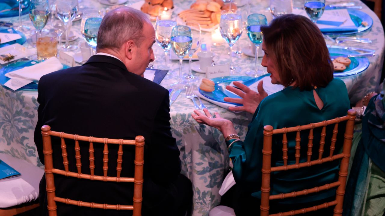 Irish Prime Minister Micheál Martin, left, talks with House Speaker Nancy Pelosi during a gala at the National Building Museum in Washington, DC, Wednesday. Martin left the event after testing positive for Covid-19.