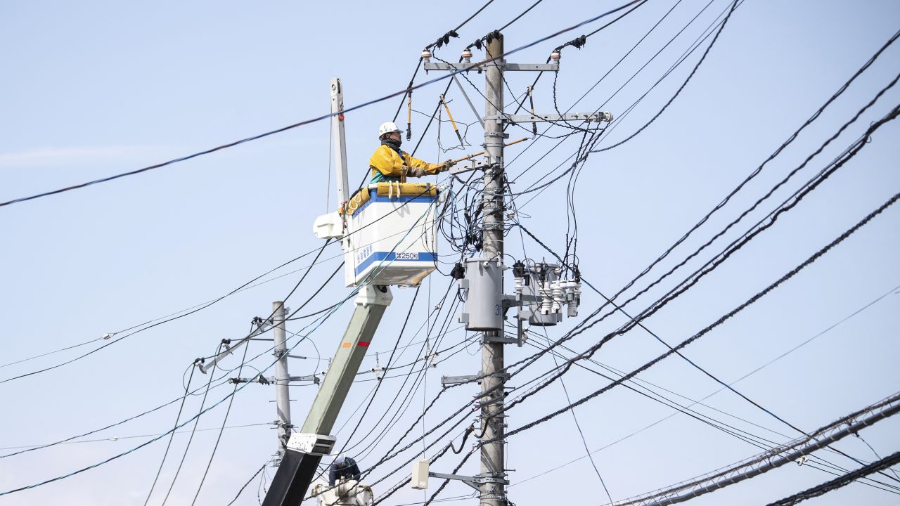 A worker conducts electrical work following a power outage in Soma, Fukushima Prefecture, Japan, on March 17.