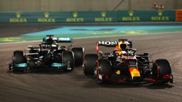 Max Verstappen of the Netherlands driving the (33) Red Bull Racing RB16B Honda overtakes Lewis Hamilton of Great Britain driving the (44) Mercedes AMG Petronas F1 Team Mercedes W12 to claim a dramatic victory on the final lap of the race to win his first Formula 1 World Title during the F1 Grand Prix of Abu Dhabi at Yas Marina Circuit on December 12, 2021 in Abu Dhabi, United Arab Emirates.