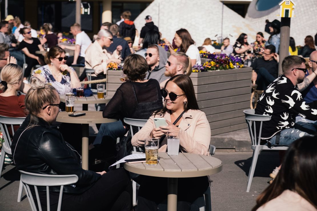 People gather for drinks on a sunny day in Helsinki in June 2020. For the fifth year in a row, Finland has ranked as the world's happiest country.