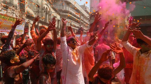 A crowd throws colored powder into the air during the Holi festival in Hyderabad, India.