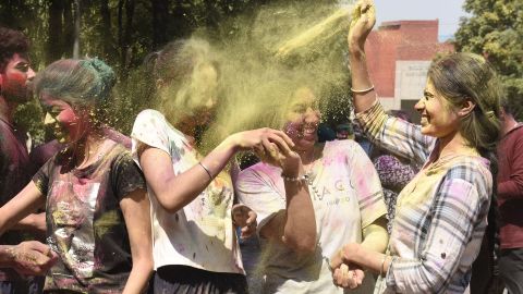 Students apply colored powder on each other at Guru Nanak Dev University in Amritsar on March 17.