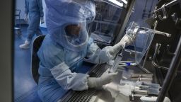 An employee prepares a syringe of raw materials for messenger RNA (mRNA), the first step of Covid-19 vaccine production, at the BioNTech SE laboratory in Marburg, Germany, on Saturday, March 27, 2021.