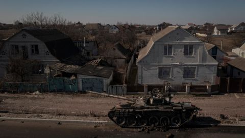 A destroyed tank sits on a street after battles between Ukrainian and Russian forces on a main road near Brovary, north of Kyiv, Ukraine, Thursday, March 10, 2022.