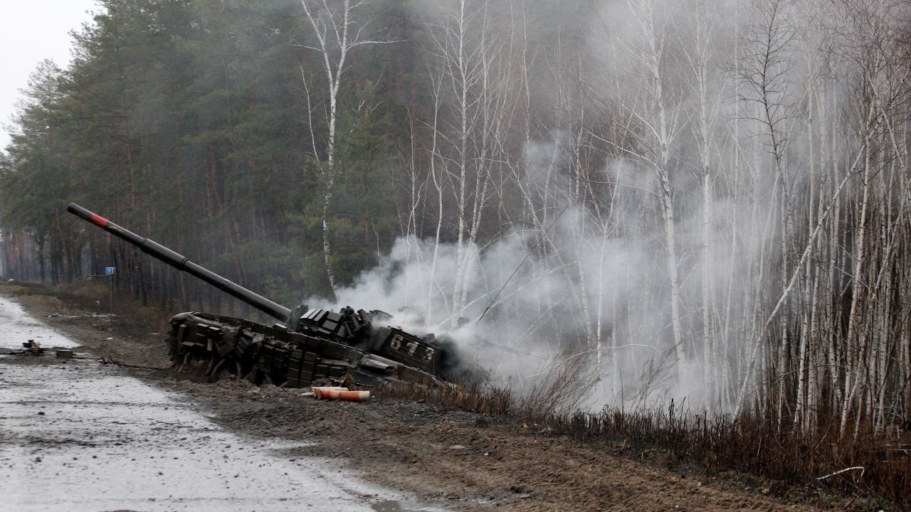 Smoke rises from a Russian tank destroyed by the Ukrainian forces on the side of a road in Lugansk region on February 26, 2022.