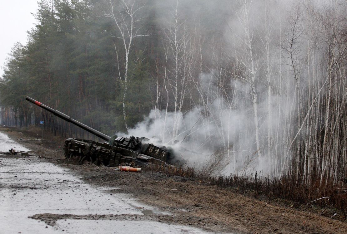 Smoke rises from a Russian tank destroyed by the Ukrainian forces on the side of a road in Lugansk region on February 26, 2022. Russia on February 26 ordered its troops to advance in Ukraine "from all directions" as the Ukrainian capital Kyiv imposed a blanket curfew.