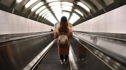 A woman rides on an subway escalator on July 14, 2021 in New York City. 