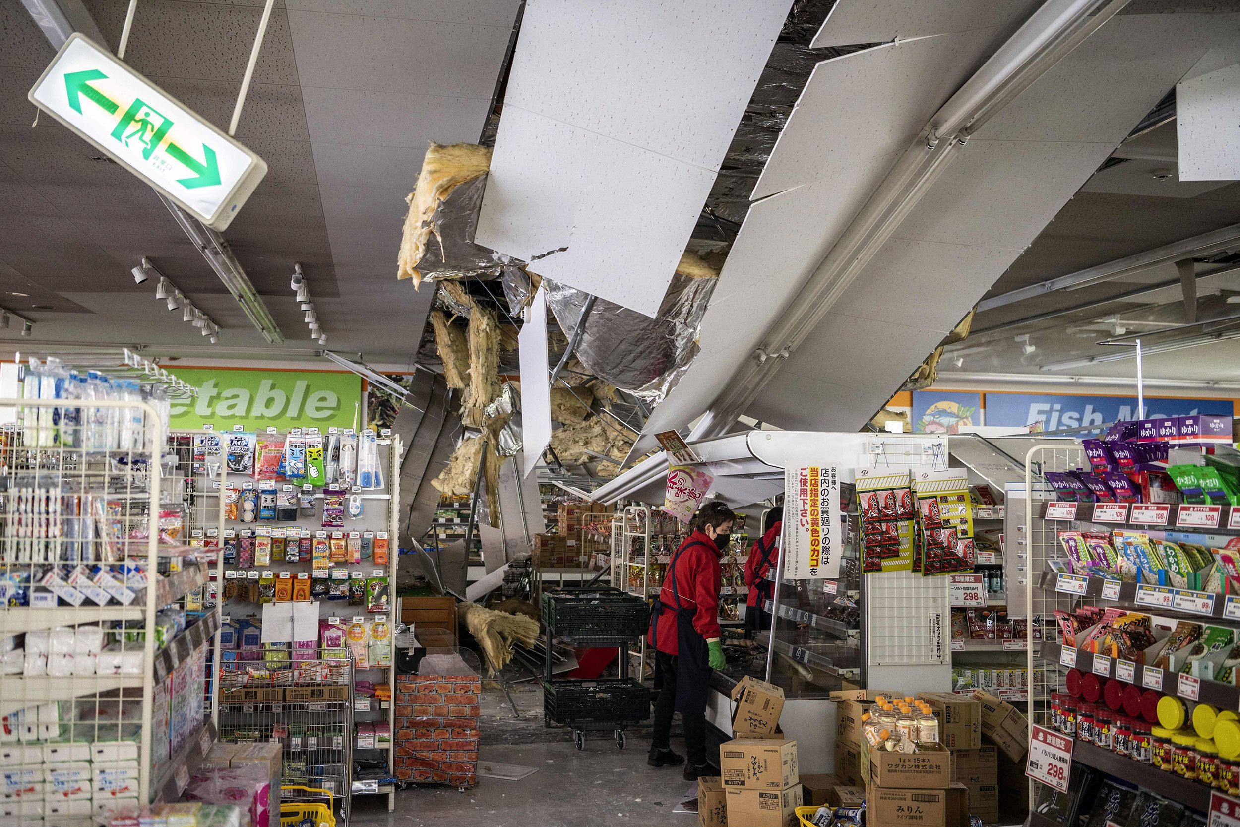 A ceiling is damaged at a supermarket in Shiroishi, Japan, on Thursday, March 17, after a 7.4 magnitude earthquake hit eastern Japan the night before.