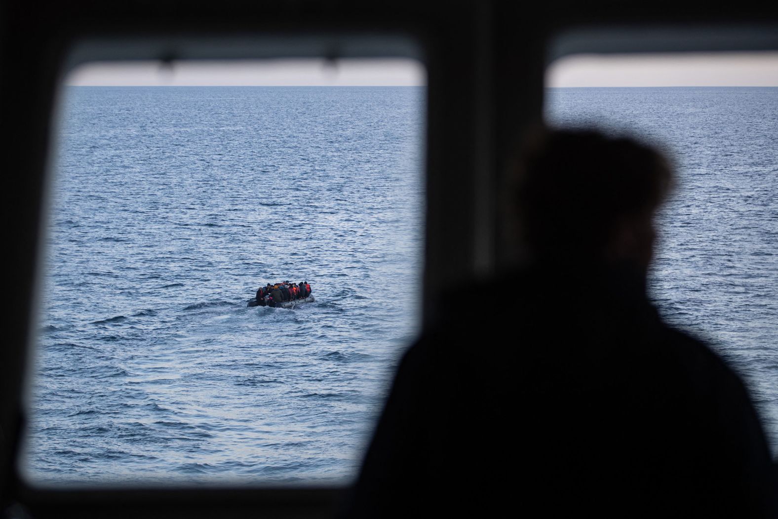 Migrants are seen in the English Channel as they try to cross from France into Britain on Monday, March 14.