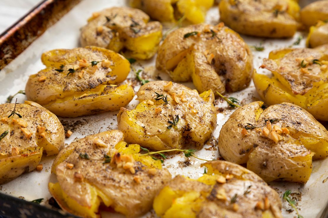 Homemade garlic-thyme smashed potatoes are soft and creamy on the inside with a crunchy exterior.