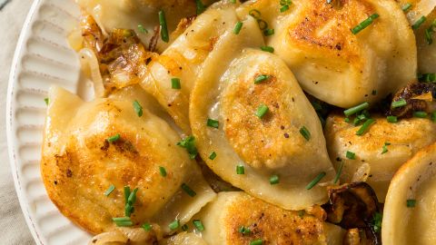Pure starchy comfort can be found in a homemade Polish potato pierogi with onions and chives.