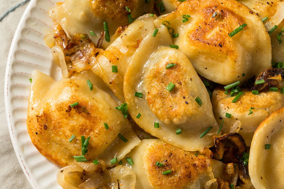 Pure starchy comfort can be found in a homemade Polish potato pierogi with onions and chives.