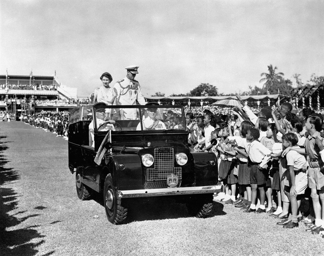 The Queen and Duke of Edinburgh drive past children in Sabina Park, Kingston, during their visit to Jamaica in 1953.