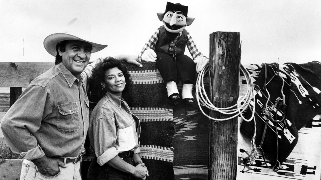 Emilio Delgado (left) and Sonia Manzano (center) co-starred on "Sesame Street" for decades (along with the Count, seated on a fence). Manzano remembered Delgado in a piece for Time. 