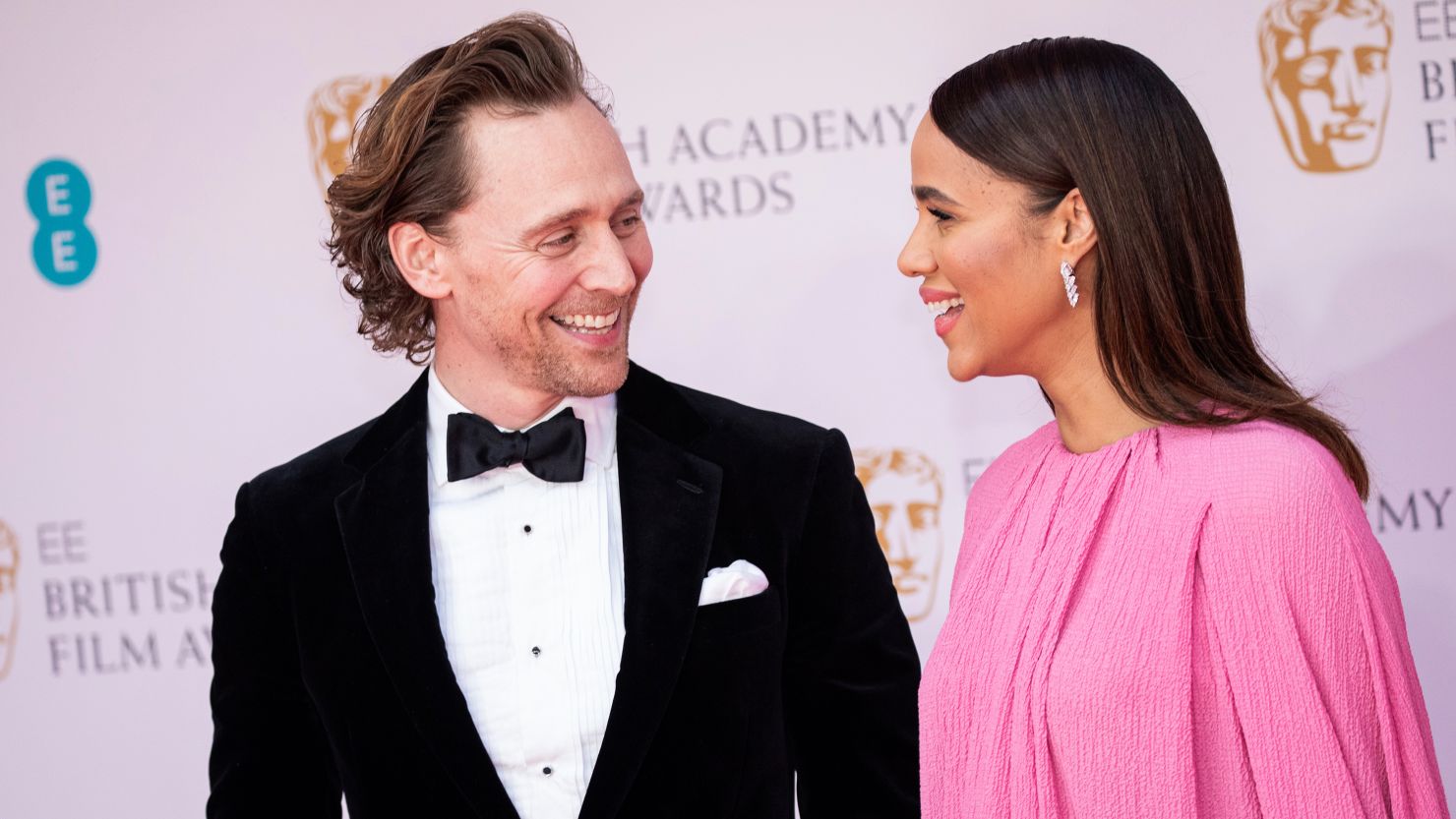 Zawe Ashton and Tom Hiddleston pose for photographers upon arrival at the 75th British Academy Film Awards in London on Sunday, March 13, 2022. 