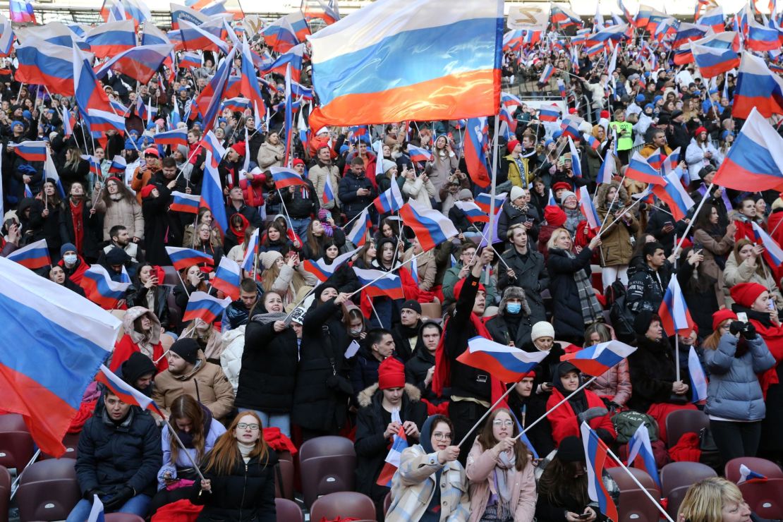 Russians hold flags and cheer during the concert that featured live music and speeches from high-profile Putin supporters.