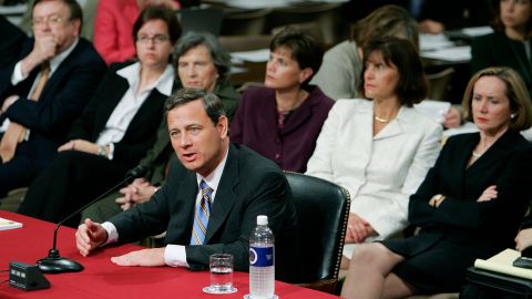 Then-nominee John Roberts answers questions as his wife, Jane Sullivan Roberts (right), watches during his third day of confirmation hearings in September 2005.