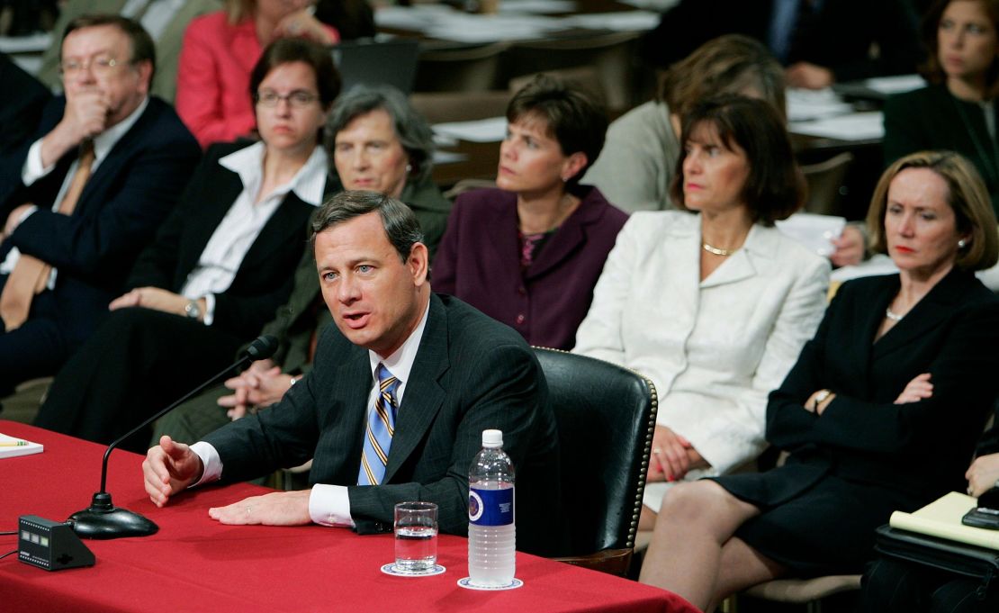 Then-nominee John Roberts answers questions as his wife, Jane Sullivan Roberts (right), watches during his third day of confirmation hearings in September 2005.