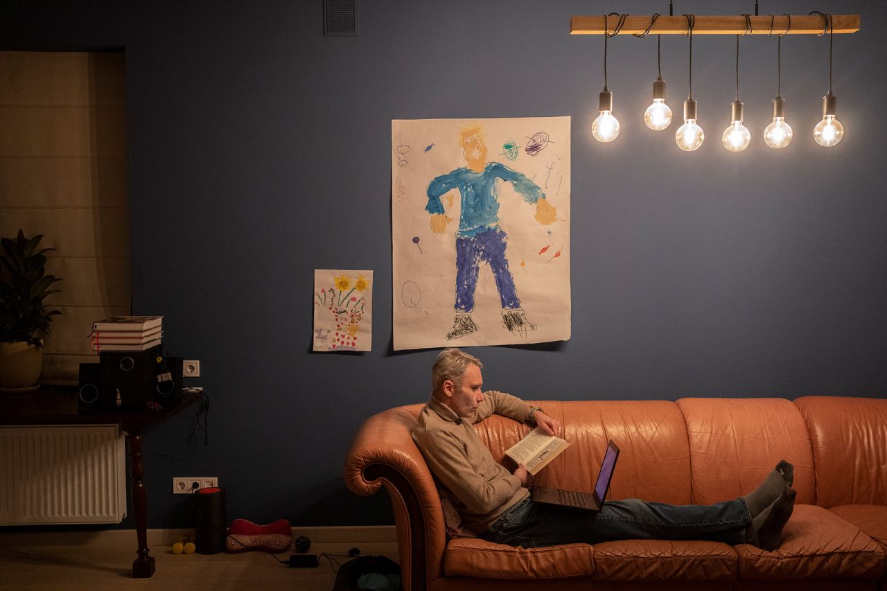 Yevhen Potoplyak reads a story to his sons, Ostab and Denys, via a video call in Lviv on March 17. His wife and children fled to Poland in February. Men between the ages of 18 and 60 aren't allowed to leave the country.