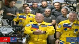 In this frame grab from video provided by Roscosmos, Russian cosmonauts Sergey Korsakov, Oleg Artemyev and Denis Matveyev are seen during a welcome ceremony after arriving at the International Space Station, Friday, March 18, 2022, the first new faces in space since the start of Russia's war in Ukraine. The crew emerged from the Soyuz capsule wearing yellow flight suits with blue stripes, the colors of the Ukrainian flag.