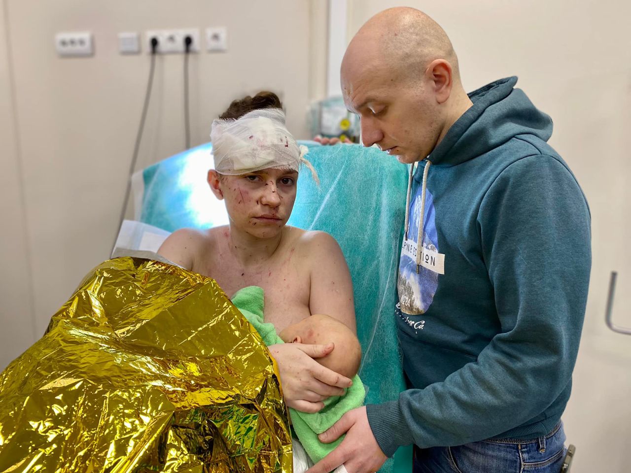 A woman named Olga feeds her 1-month-old daughter as her husband, Dmytro, looks on at the Ohmatdit Children's Hospital. According to a Facebook post from the hospital, <a href="https://edition.cnn.com/europe/live-news/ukraine-russia-putin-news-03-20-22/h_5b55ab092b9277fafc223f5bbd91a38f" target="_blank">Olga shielded her baby with her body</a> while their home was being shelled in Kyiv. The child was unharmed, but Olga sustained multiple injuries, the post said.