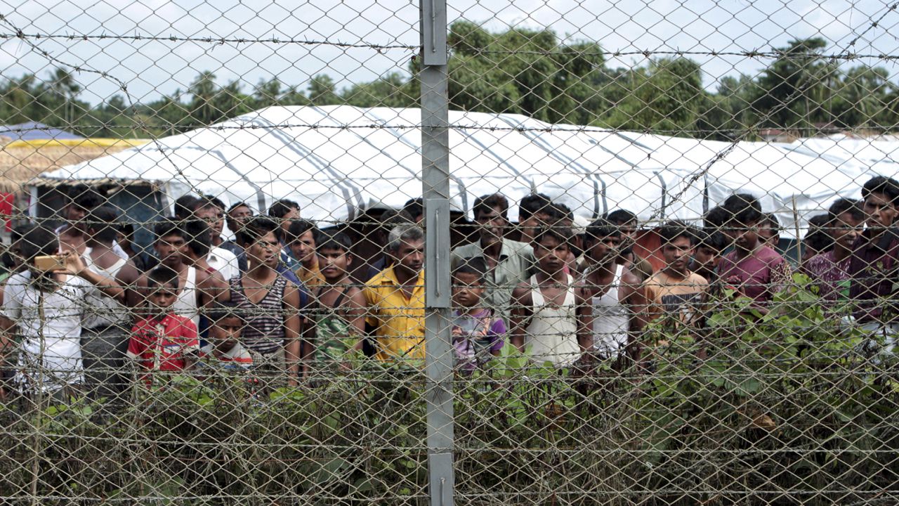 Rohingya refugees gather near a fence during a government organized media tour, to a no-man's land between Myanmar and Bangladesh, near Taungpyolatyar village, Maung Daw, northern Rakhine State, Myanmar, June 29, 2018. 