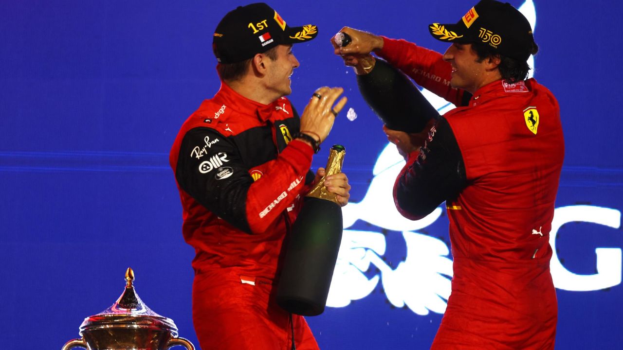Leclerc and Carlos Sainz celebrate on the podium after securing a Ferrari one-two. 