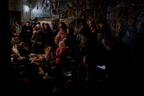 People gather in a basement during an air raid in Lviv on Saturday, March 19.