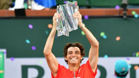 Taylor Fritz hoists the Indian Wells championship trophy after defeating Rafael Nadal.