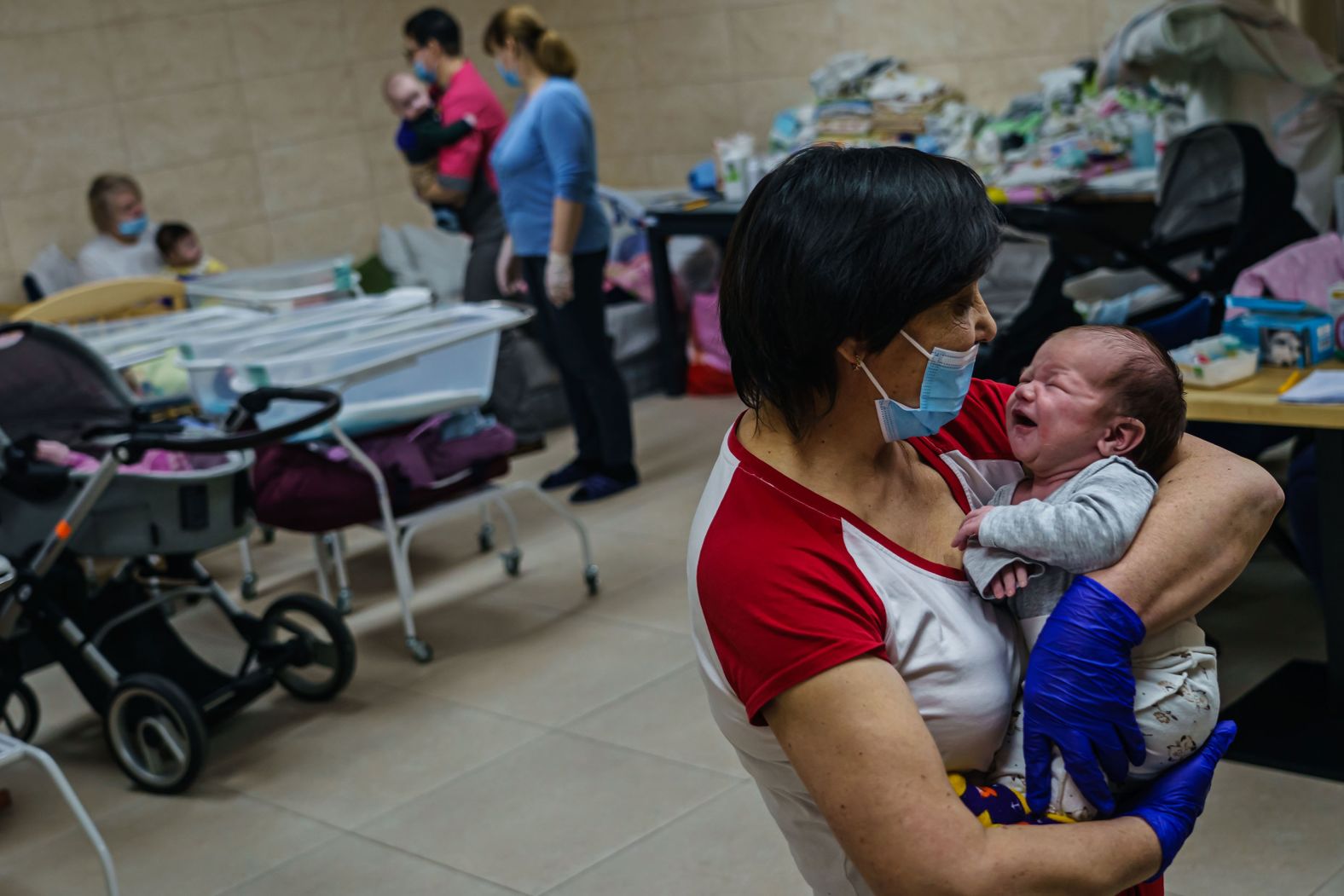 Svetlana Stetsiuk tries to comfort an infant in a makeshift underground nursery on the outskirts of Kyiv on March 20.