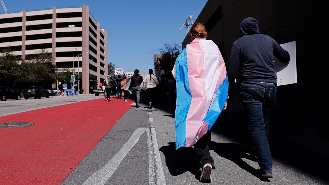 Dylan Yeary (left) wears the trans flag during a rally for trans rights that marched through the streets of  Austin, Texas, in February.