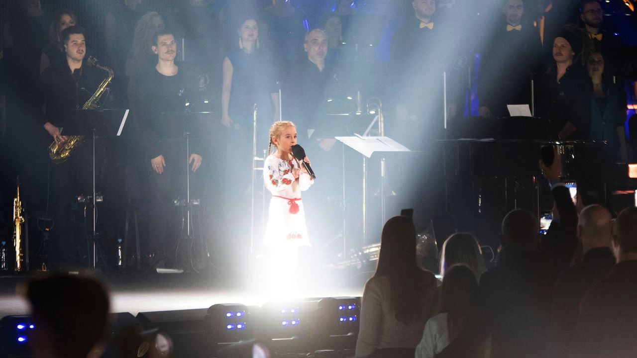Amellia Anisovych, a refugee from Ukraine, sang the Ukrainian national anthem at a benefit concert in Łódź, Poland. 