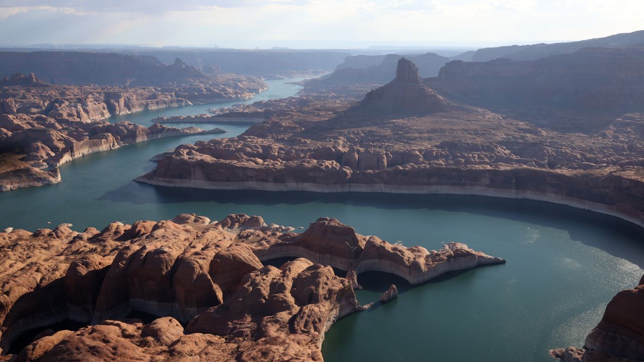 The white "bathtub ring" -- which shows how much the water level has dropped below full capacity -- is visible on the rocky banks of Lake Powell in June 2021.