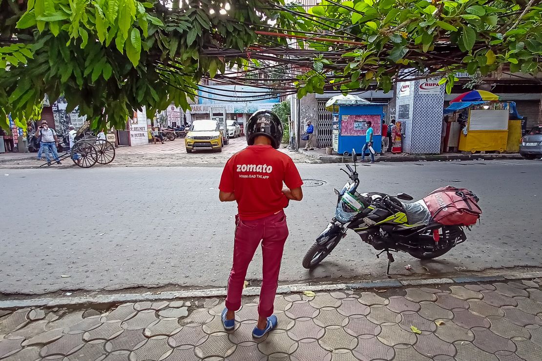 A Zomato food delivery partner is seen on a road in Kolkata, India, on July 14, 2021.