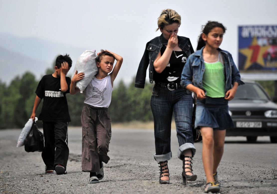 A Georgian family leave the town of Gori on August 12, 2008, following shelling.