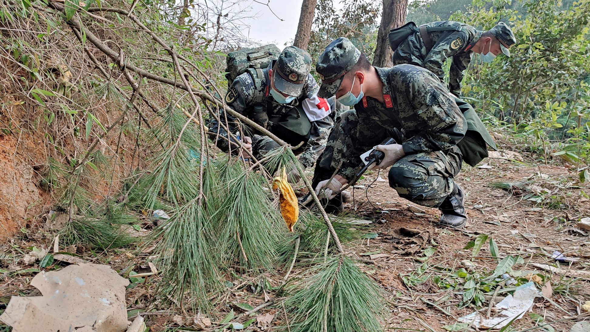 Paramilitary police officers search the site of the China Eastern Airlines plane crash in China's Guangxi province on March 22.