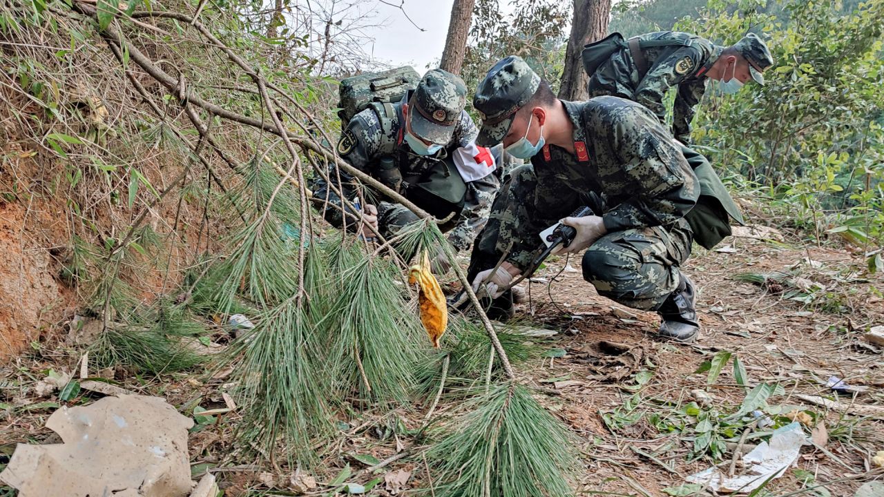Paramilitary police officers search the site of the China Eastern Airlines plane crash in China's Guangxi province on March 22.